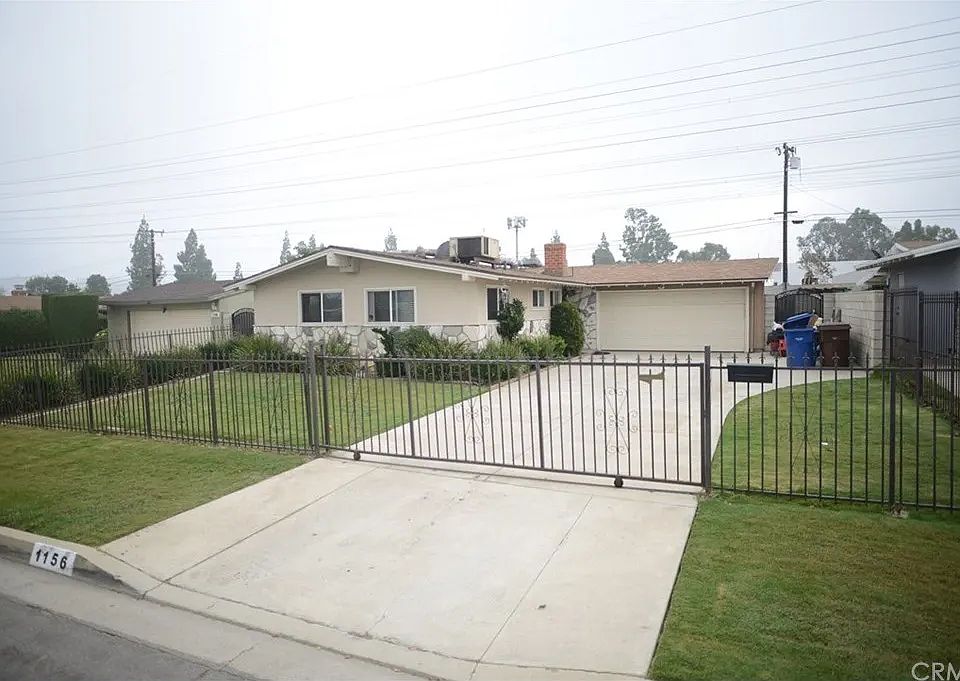Huge front yard with secured gate, capable of fitting multiple vehicles. Atleast 6 easily not including the garage gas 2 spaces