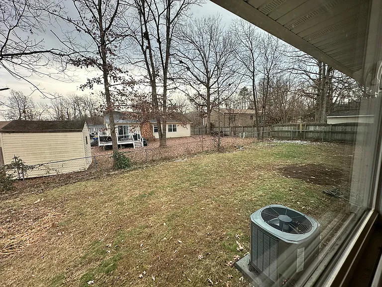 View of the backyard from the large window in the kitchen.