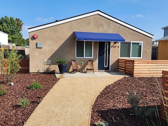 Pathway to home with gated yard.