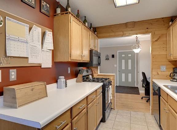 Updated kitchen with newer appliances and custom cabinets.