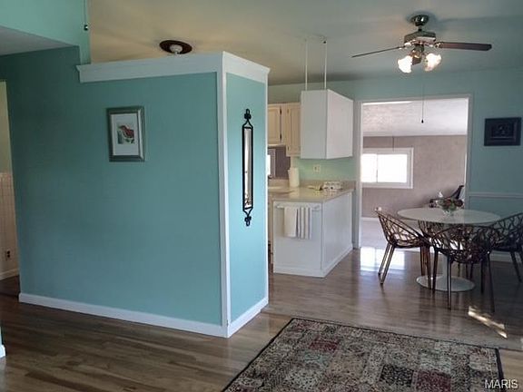 The view from the front living room toward the kitchen, dining room and huge family room . The ceiling is vaulted with a wall of windows allowing so much light into this home.