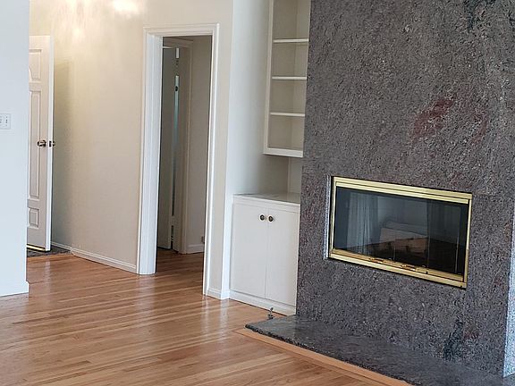 Living room with build ins and fireplace view 