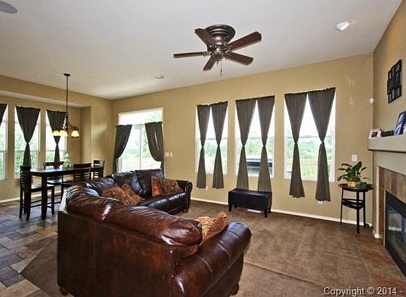 Great room with windows lining the walls to let natural light stream in