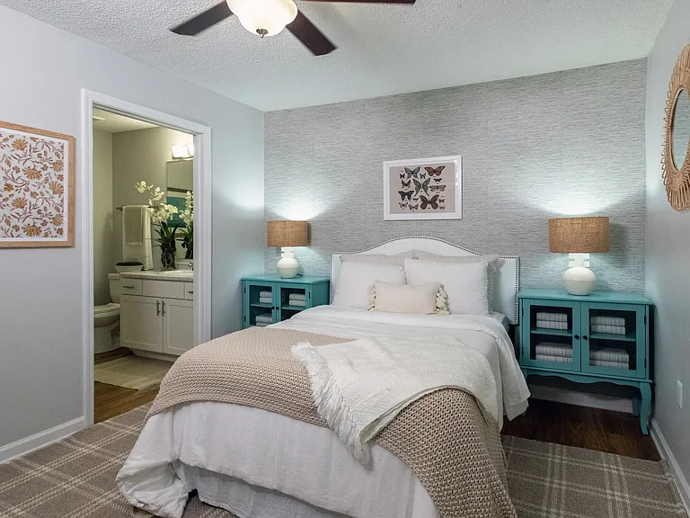 Step into the serenity in our primary bedroom at Emerson Isles. The private access to your en suite bathroom and the comforting breeze from the ceiling fan create a haven of tranquility.