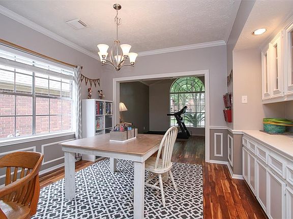 SO hard to find a home with so much storage and built ins as this home has,   This elegant formal dining room has the same low maintenance gorgeous wood floors, crown molding, decorative wainscoting, and yes those gorgeous and functional built ins!