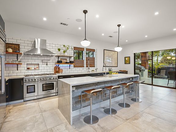 Chef's kitchen with marble counters and large island