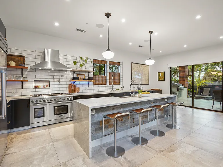 Chef's kitchen with marble counters and large island