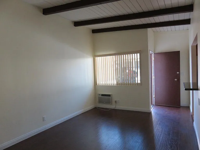 Living area looking at front door. Kitchen is to right.