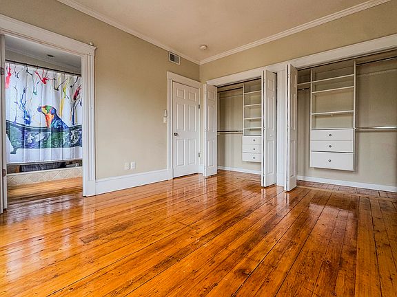 Primary bedroom w/ closet doors open