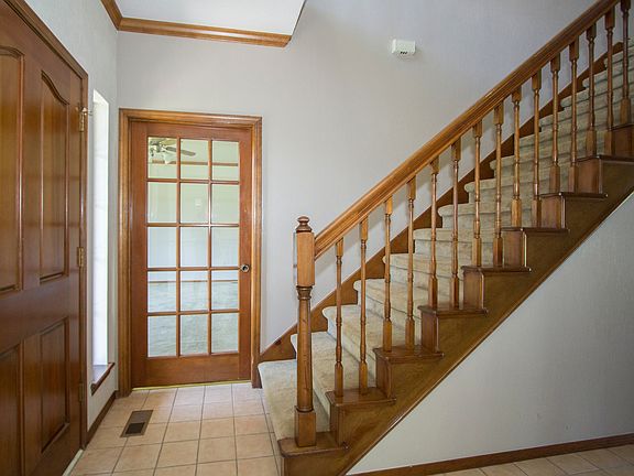 Carpeted StairsTiled Entryway