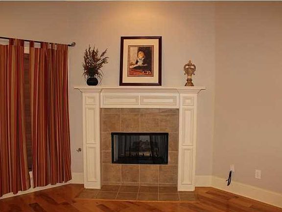 Family room with gas log fireplace & beautiful hardwood floors.