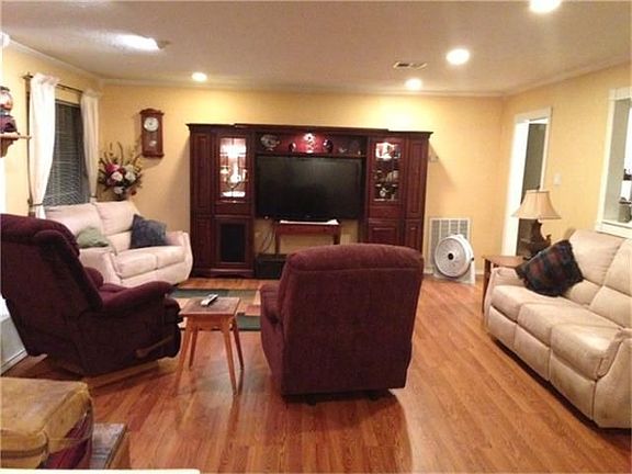 Another view of just how large this family room  is!  Complete with laminate wood flooring.
