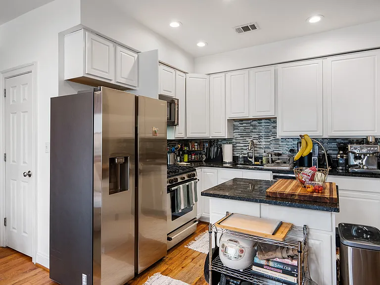 from foyer stairs walk in to the living space to include the kitchen and living room and hallway to bedrooms