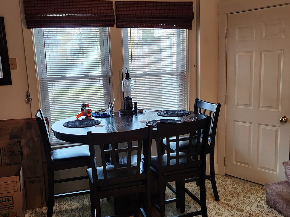 Windows look out to the porch and yard.