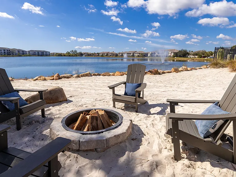 Enjoy cozy evenings by the fire with Adirondack seating and breathtaking lake scenery.