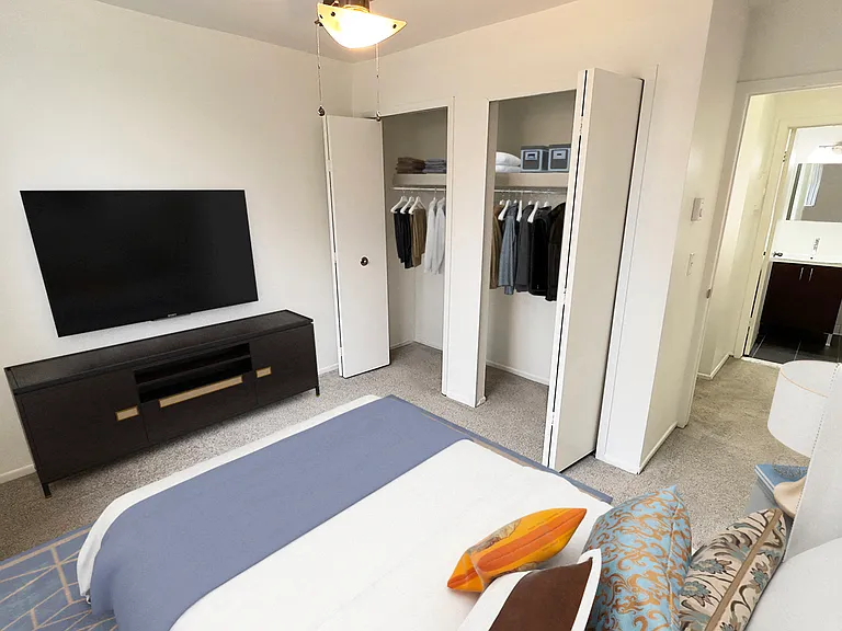 2 bedroom, 820 sq. ft. apartment flat with upgraded interior features like stainless steel appliances, white kitchen cabinets, wood plank floors.
