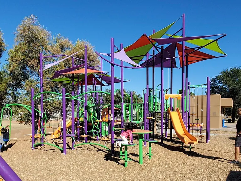 Multiple playground structures and swings