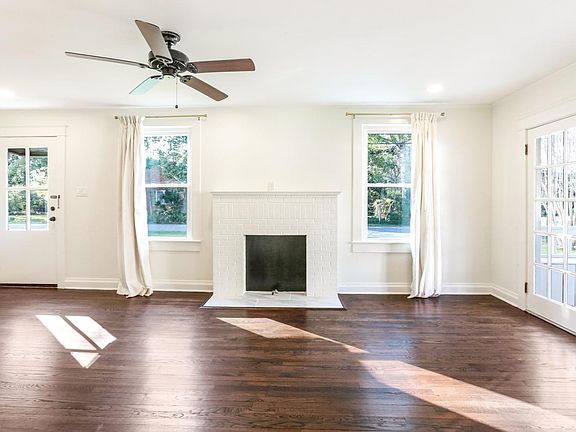 Living room with fireplace and custom drapes