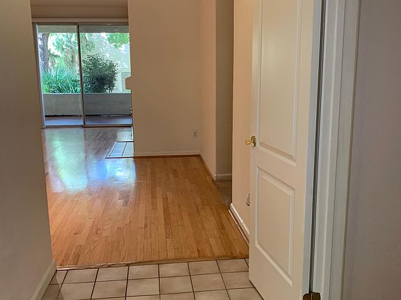 Entrance to condo, kitchen is to the left. Door is open to the coat closet on the right.