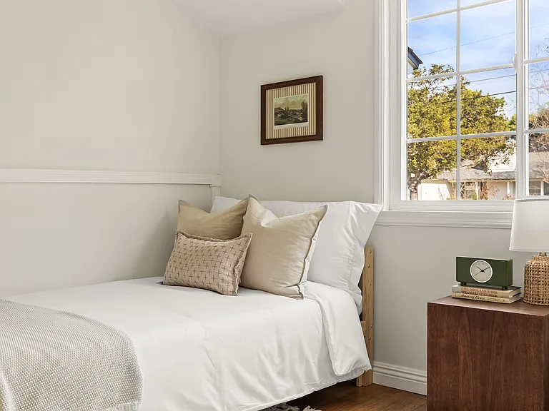Third bedroom with two twin beds, built-in storage, and closet space, with a crib available upon request.