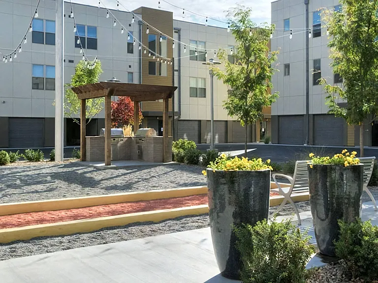 Community Patio Area Featuring Grilling Stations and Decorative Planters