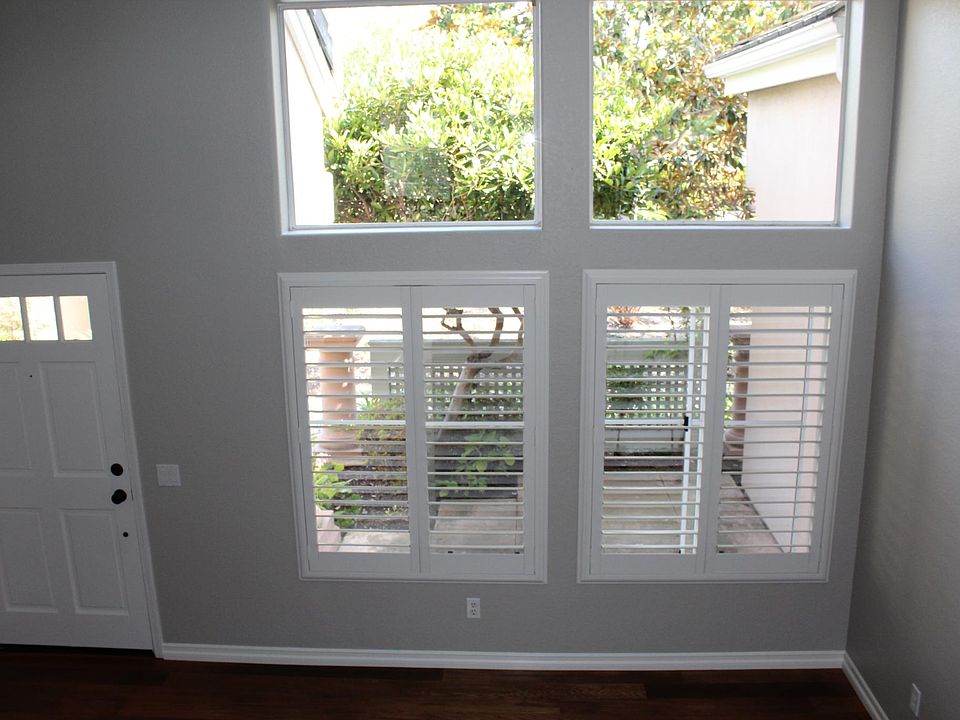 Living room with high ceilings, crown molding, and lot of windows for natural light