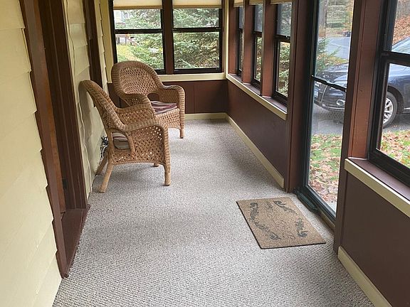 Beautiful enclosed front porch.