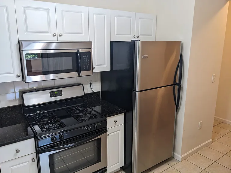 Kitchen with granite countertop and stainless steel appliances