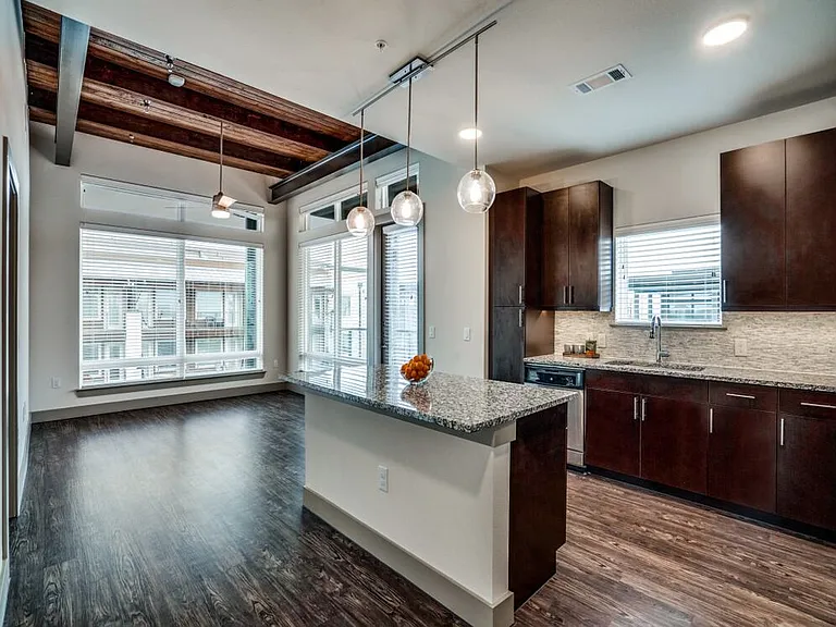 Espresso finish package kitchen with tile backsplash, speckled granite countertop, hard surface flooring, and pendant lighting
