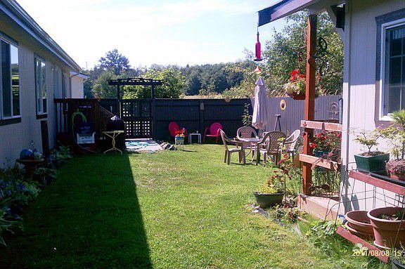 Fenced-in back yard with outbuilding.
