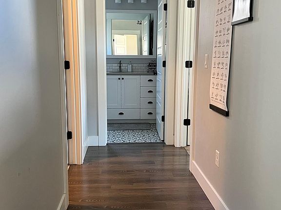 Hallway to bedroom 1, main bath, and laundry