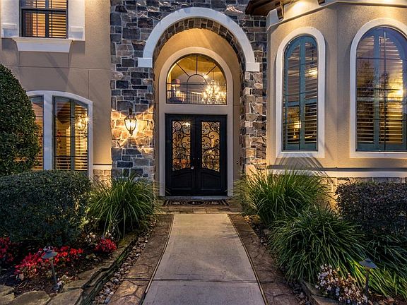 Beautiful lighting and a welcoming entry are pleasing day or night. Thoughtful landscaping in the front and a well-designed resort atmosphere in the back.