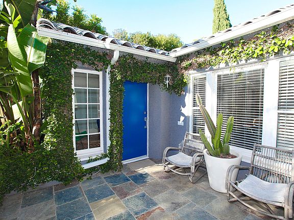 Front porch and front door. Great space to catch some sun or have a glass of wine.