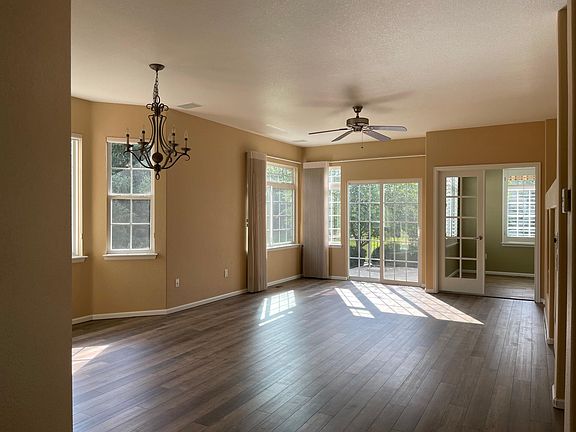 Dining and Family room, exits to the fenced patio surrounded by green belt, with study room next to it.