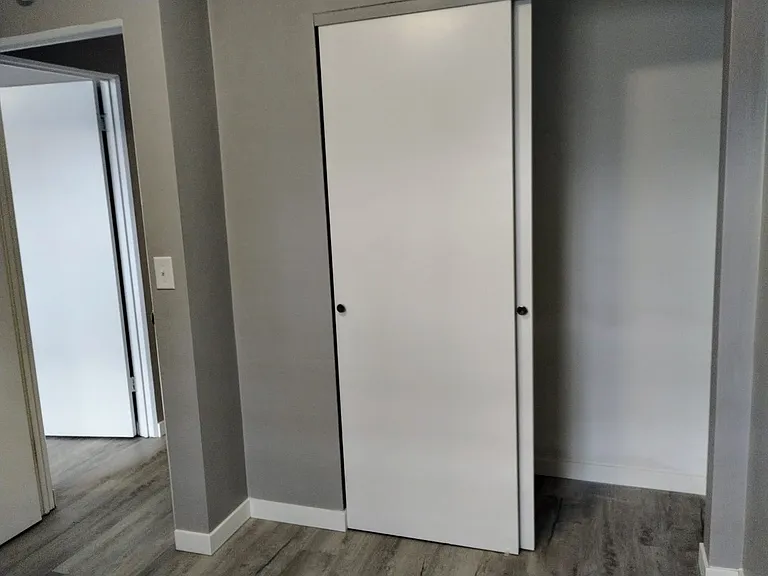 BEDROOM WITH NEW FLOORING & NEWLY PAINTED WALLS.
