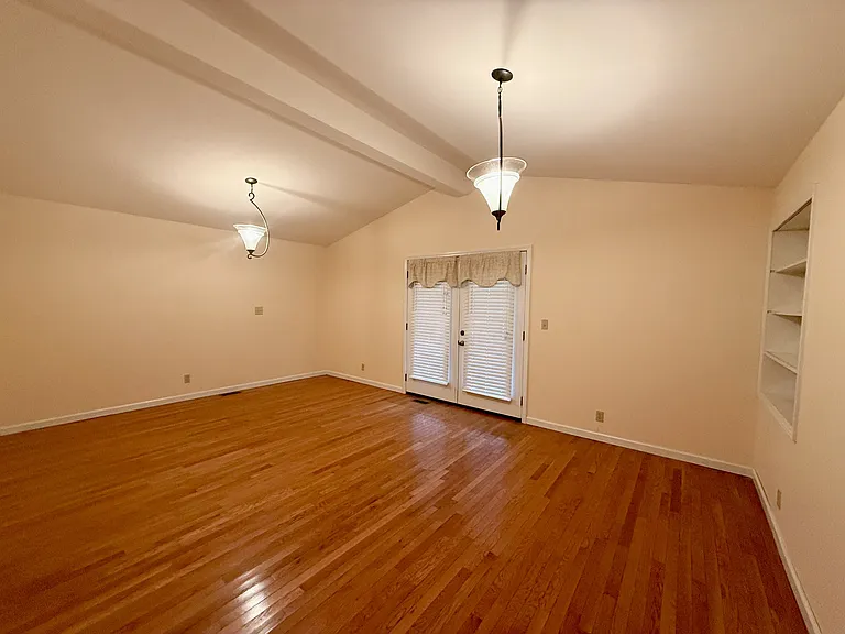 Spacious living room with French doors to the covered front porch.