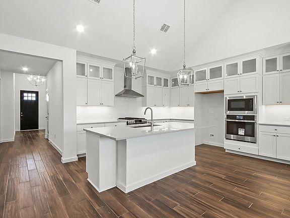 Kitchen with stacked glass-front upper cabinets