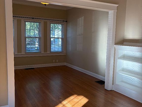 Front room connected to living room with fireplace
