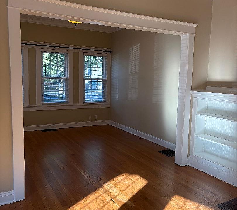 Front room connected to living room with fireplace