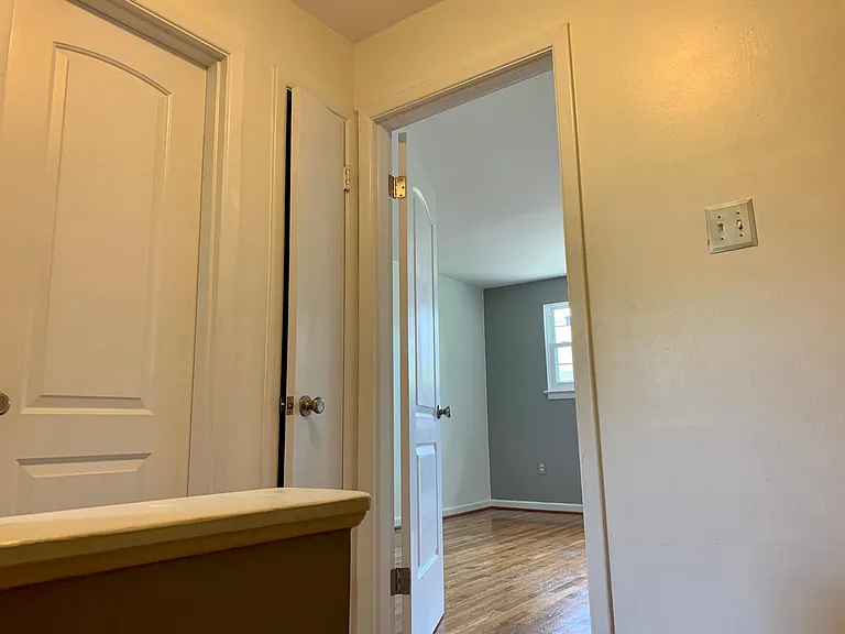 Second floor landing with two bedrooms, full bath, and linen closet.