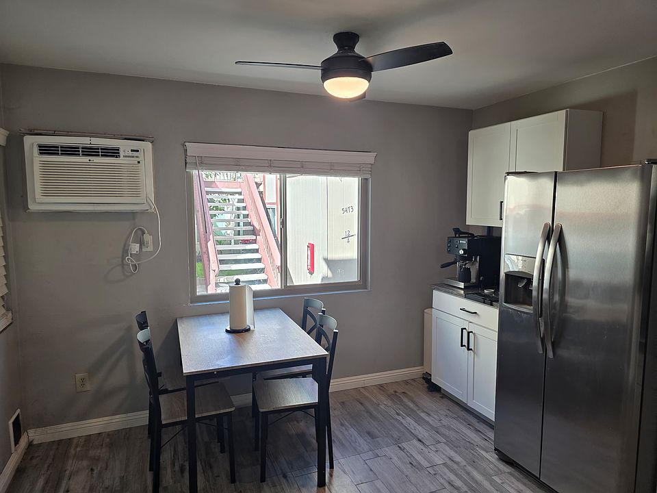 Kitchen eating area. Brand new appliances and ceiling fan installed in 2021. New air conditioner installed 2024. Quartz counter tops and porcelain tile.