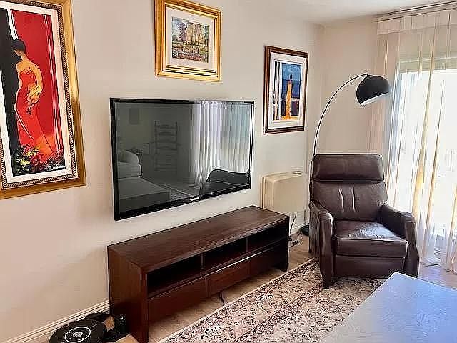 Living room - west facing window, All windows have new fabric vertical blinds and blackout shades. Ethan Allen recliner, TV table and coffee table. Again all furniture and art removable.