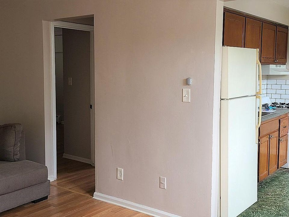 Livingroom looking toward kitchen on right & bedroom / bathroom on left. 
Free sectional sofa or we will remove it.