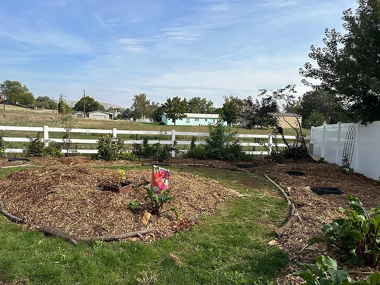 landscaping beds have shrubs, and flowers in summer