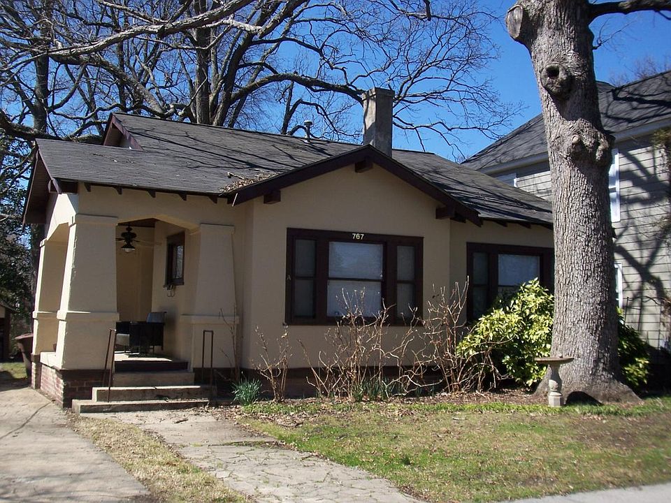 Front of house w/ side sitting porch & fan