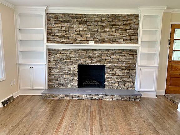 Stone fireplace with shelves
