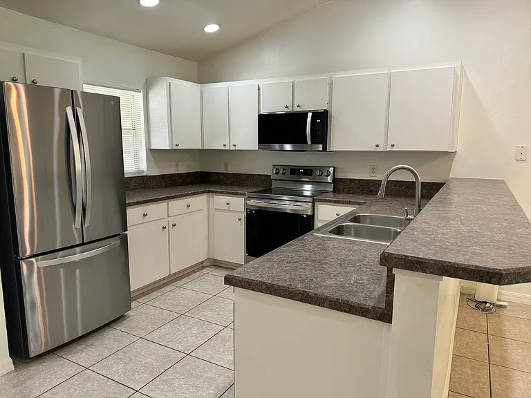 New stainless steel appliances including fridge, stove, microwave and dishwasher