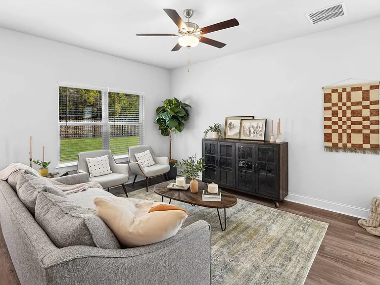 Living room with large window letting in a ton of natural light.