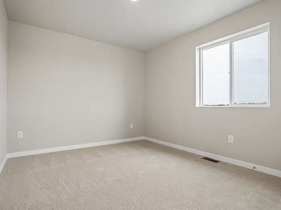 The master bedroom is spacious with a large window.