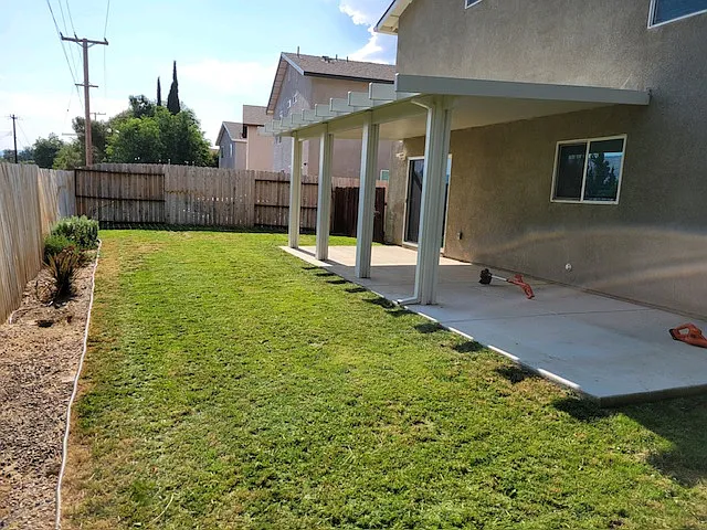 Backyard including covered back patio.